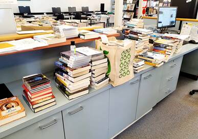 Piles of books ready for pre-delivery yesterday, up to 450 library items have been delivered in a day since the new restrictions came in place. 