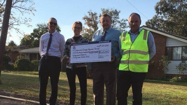 CGRC General Manager Phil McMurray, Member for Cootamundra Steph Cooke, CGRC mayor Cr Abb McAlister and CGRC Manager for Civil Works Mark Ellis in French Street Cootamundra last week, with the cheque representing the $4.6 million from the Fixing Local Roads Program and inspecting the work that will be carried out to alleviate the drainage damage.