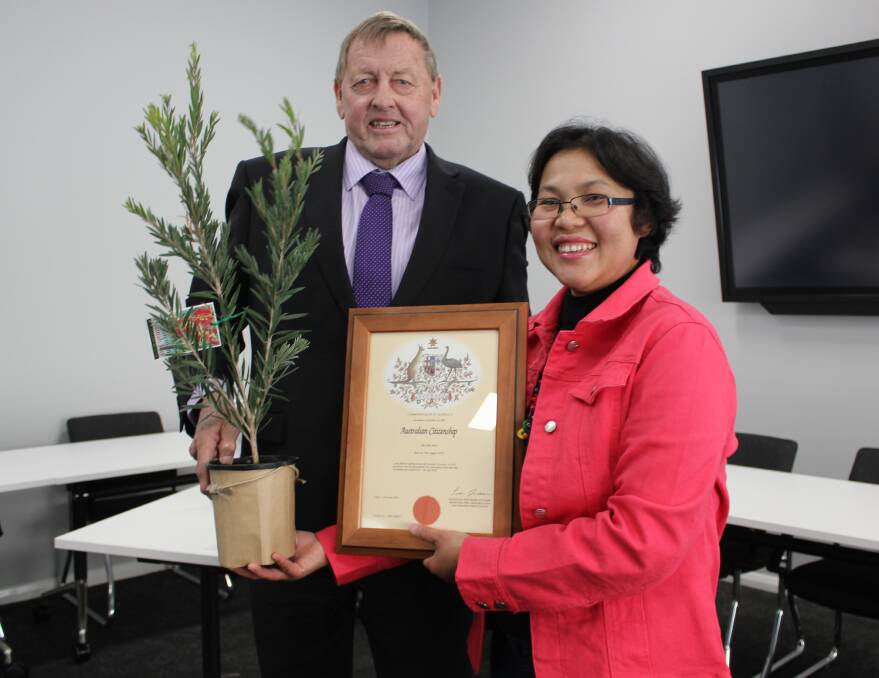 MOMENTOUS DAY: New Australian citizen Cho Thae Win Cohen receives her certificate and native plant from Cootamundra-Gundagai mayor Abb McAlister.