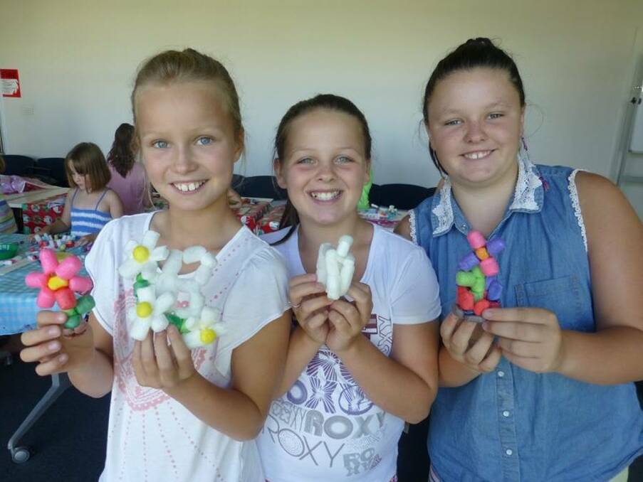LIBRARY FUN: Lizzie Bragg, Trysta Willoughby and Abbey Gammon with their creative creations from packing beads event at the library. Picture: Contributed
