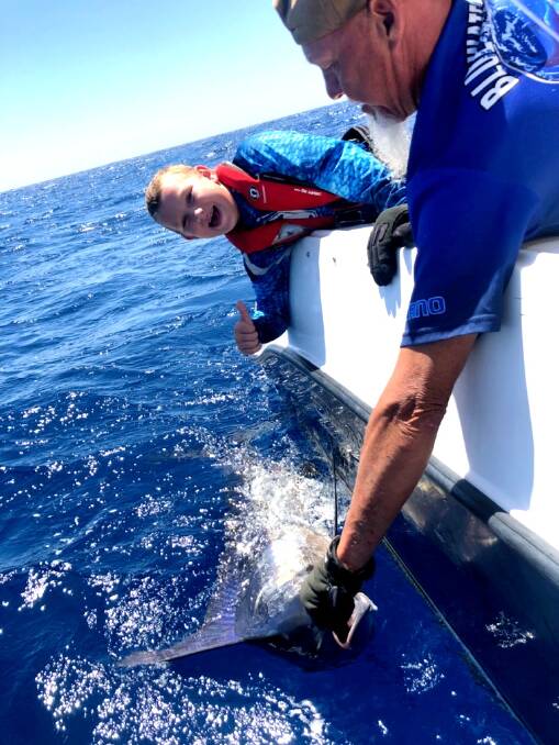 WHAT A DAY: Jack Warden lands his first two marlins recently, at Bermi, at the tender age of 10. Picture: Contributed