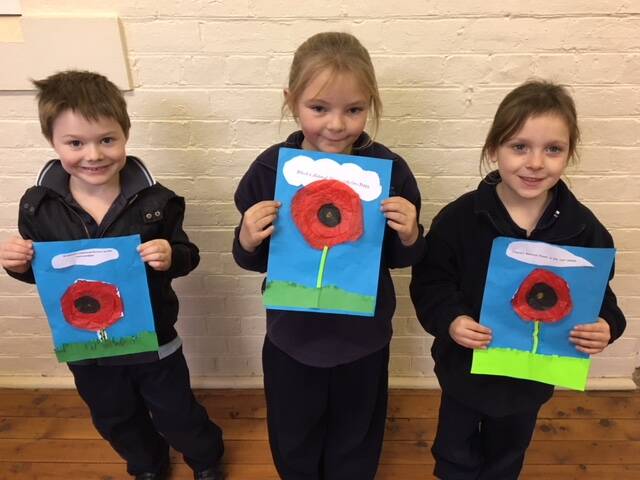 POPPY PERFECT: Stewart Anderson,Kasey Evelyn and Anna Clark with their artwork completed at Wallendbeen Public School as part of the presentation to the CWA. 