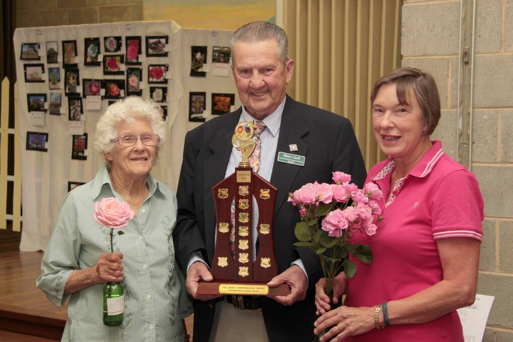 BEAUTIFUL BLOOMS: Joan Arkinstall, winner of the Jenny Cash Memorial Champion Rose, judge Peter Cash and Kerry Byrne, Best Exhibit Frank and Muriel Lewis Memorial Award Roses at the show. PIcture: Kelly Manwaring