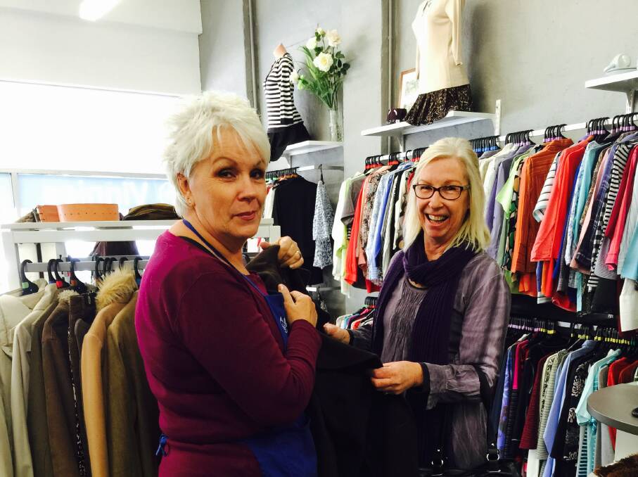 COLD SNAP: Volunteer at St Vincent’s de Paul Collen Flynn is pictured with Kerri Beardmore selecting a coat from their winter range of clothing.