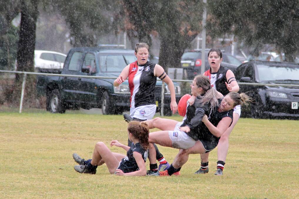 TOUGH STUFF: The Blues girls have the bye on Saturday after their impressive win over Ainslie in the rain last Saturday. Picture: Kelly Manwaring