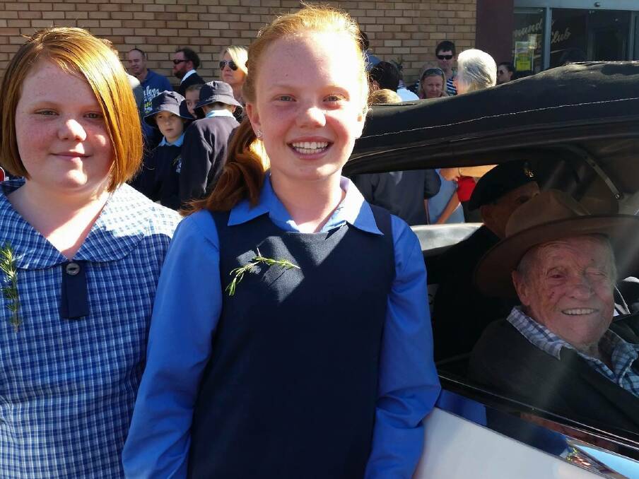 ANZAC DAY: A beautiful photo of sisters Logan and Bronte Johnson with digger Dan at the Anzac Day ceremony on Monday.