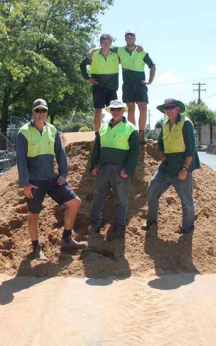 TAKING A BREAK Cootamundra Shire Council workers Aiden Maxwell and Bevan Collins with Steve Lowe, Michael Collins and Graeme McCallum get started putting the sand in place on Wednesday. Picture: Jennette Lees 