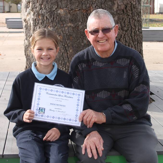PROUD REPRESENTATIVE: Cootamundra Public School student Andie McTavish, year five, with the Cootamundra Sports Foundation's Eric Thorburn after Mr Thorburn presented her a cheque to help with her Riverina touch footy rep duties. Picture: Jennette Lees  