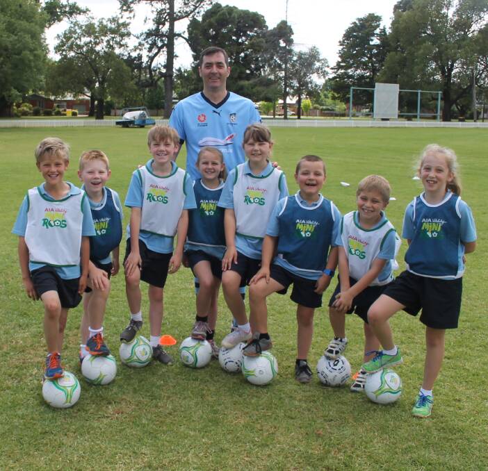 NEW SKILLS: Students Jack Clancy, Oscar Philp, Ben Brown, Isobel Cram, Georgia Mair, Dylan Herring, Danny Moloney and Isabella Carr with MiniRoos coordinator Sam Gray learning all about football. Picture: Jennette Lees 