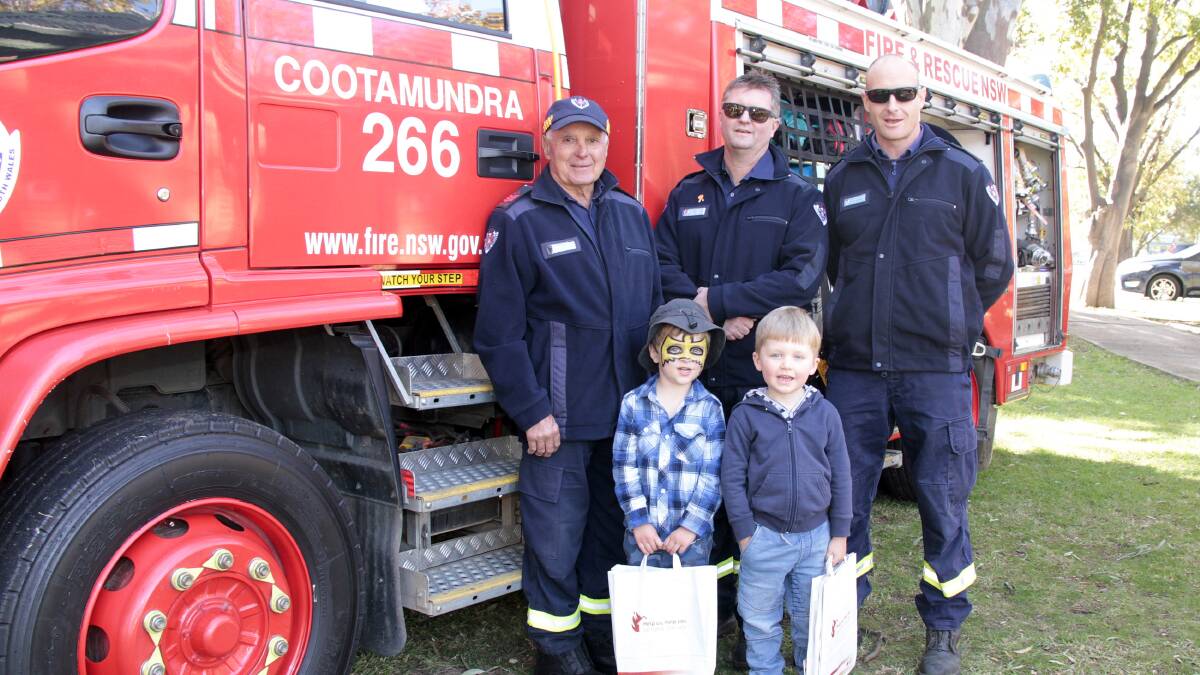 Paul Harmon from Temora, with Mal Sutherland and Aaron Walker from Cootamundra fire station with Benny Moon and Charlie Main at Thursday's Family Fun Day.