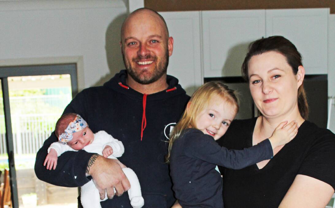 NEW ARRIVAL: Baby Harper Evans with her dad Ricky, mum Danielle and one of her big sisters, Indigo.