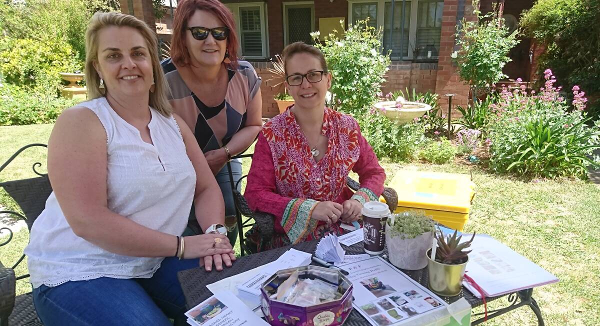 GARDEN GRINS: Sacred Heart's Emma Deep, P&F president Melissa Finnigan and assistant principal Nic Trinder greet visitors to an open garden in Thompson Street. 