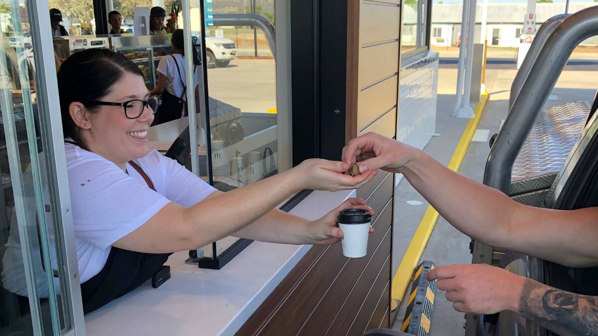 New South West Fuel staff member Tiffany Chamberlain serves drive through coffee to a customer on their grand opening day. Picture: Kellie Hancock
