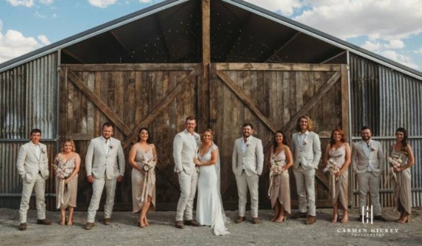 HAPPIEST TIME: Pictured here is the bridal party of Riley and Brooke Ewings - outside the top-notch reception spot that family and friends erected for their wedding at Hurleyville in February. Photo: Carmen Hickey Photography