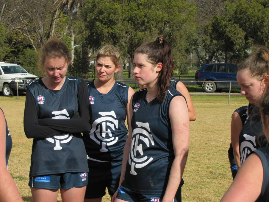 CONCENTRATION: Coota Blues players Stacey Boxsell, Jess Brien and Sarah Stephens listen intently to coach Michalea Pevceval during a break on Saturday. Picture: SUPPLIED