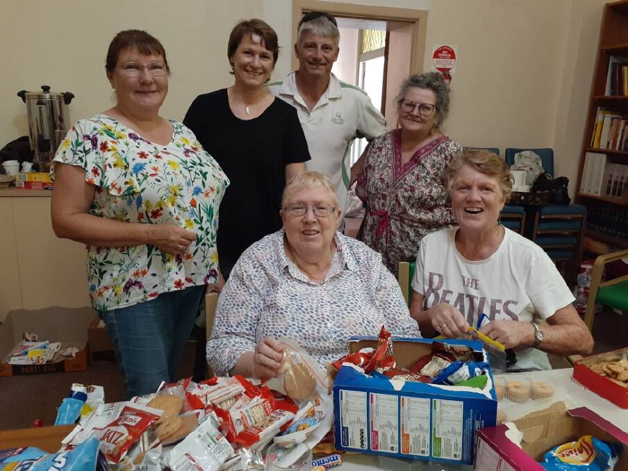 WILLING HELPERS: Some of the supporters working to pack parcels for those affected by the fires  Back: Marge Taprell, Janet & Dean Cartwright, Pamela Cohen. Front: Diane Grocott, Lindsey Baber.