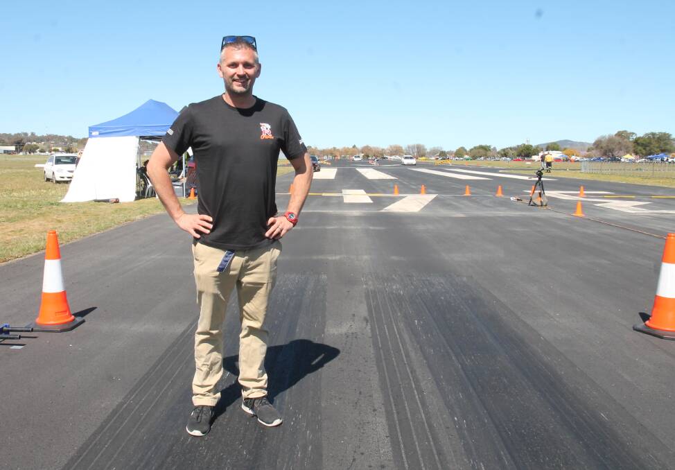 Andrew Hawkins demonstrates how shoes stick to the rubber laid down on the new launch pad, earning the hashtag "Australia's quickest runway".