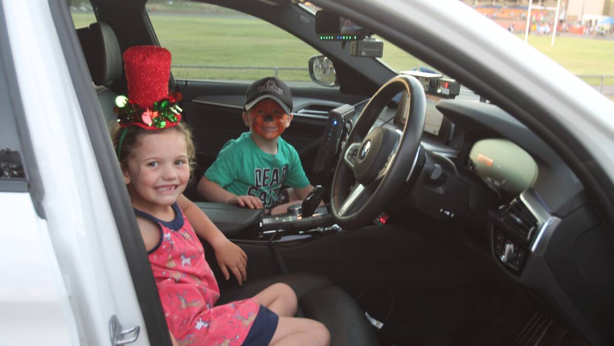Highway patrol: Sophie Knewstub and Rory Gartside in the latest model police vehicle, on display at the Christmas Fair.
