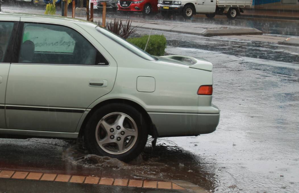 A rare sight in Parker Street in recent months: a tyre splashes water as a car enters the Woollies car park.