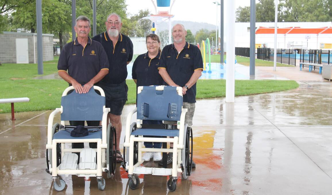 Lions Club president John Welch (right) and president Marjorie Taprell with club members Trevor Reid and Fred Byrne displaying the two wheelchairs now in use at the pool.