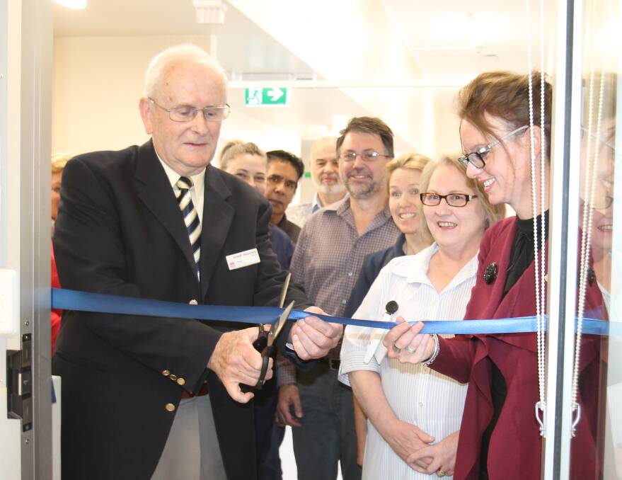 MLHD board member Geoff Twomey cuts the ribbon watched by Steph Cooke and (from left) Jess Collett, Len Connelly, Paul Braybrooks, Jacques Scholtz, Catherine Annetts and Sue McGlynn 