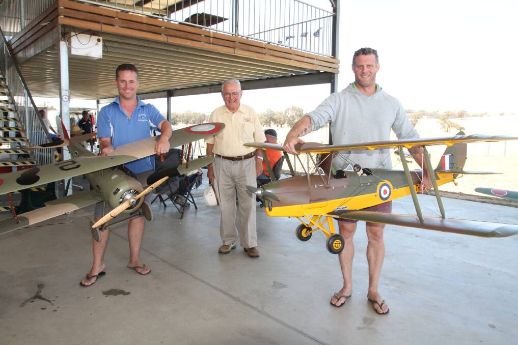 Society vice president Peter Goff (right) with his quarter-scale model of a 1938 de Havilland Tiger Moth biplane, designed as a training aircraft. Also pictured is Society member and spokesperson Bill Mansell, and president Bill Ogle with a WWI biplane. 