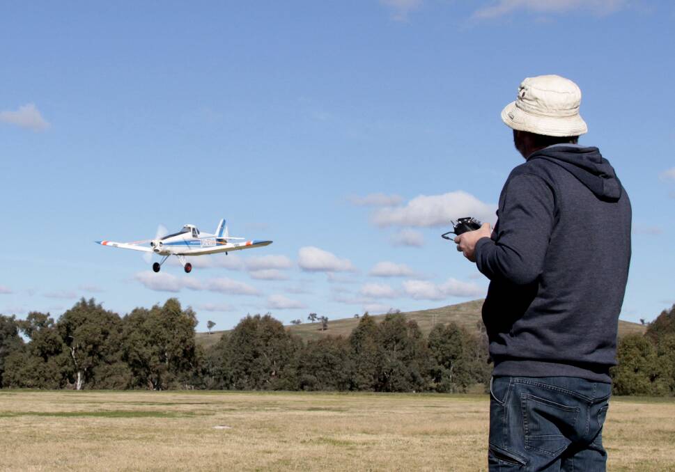 LANDING: Cootamundra Aeromodellers Club member Ross Bathie of Melbourne with his 342cc Piper Pawnee model crop duster. It is 46 per cent the size of the real thing.