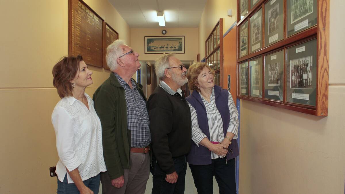  Former students Ann Beckenhauer née Evans of Nebraska USA, David Corby of the Gold Coast and high school sweethearts Stephen and Diane Baker née Law of Sydney looking at the old school photos on display at the Cootamundra High School.
