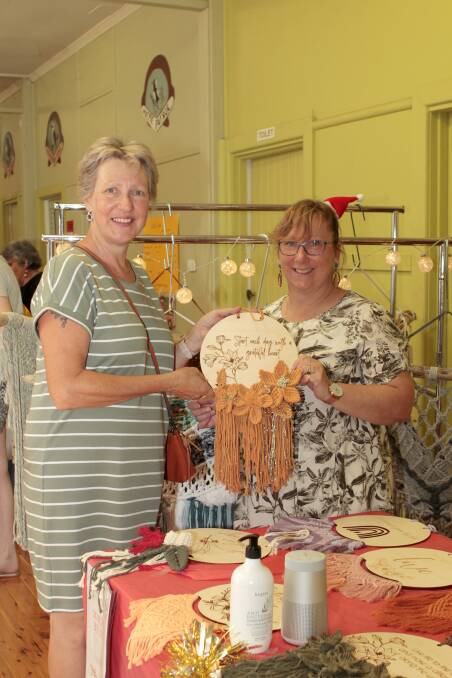 Louise Kelly and business owner Elaine Kelly of Macrame By Mrs K holding one of her custom made Macrame Wooden versed plaques.