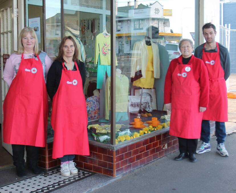 COLOUR COORDINATED: Cootamundra Red Cross Store has a green and yellow theme in its window for Wattle Time. Pictured (from left) are Sharon Douglas, Angela Dawson, Helen Ecclestone and Aaron Moore.
