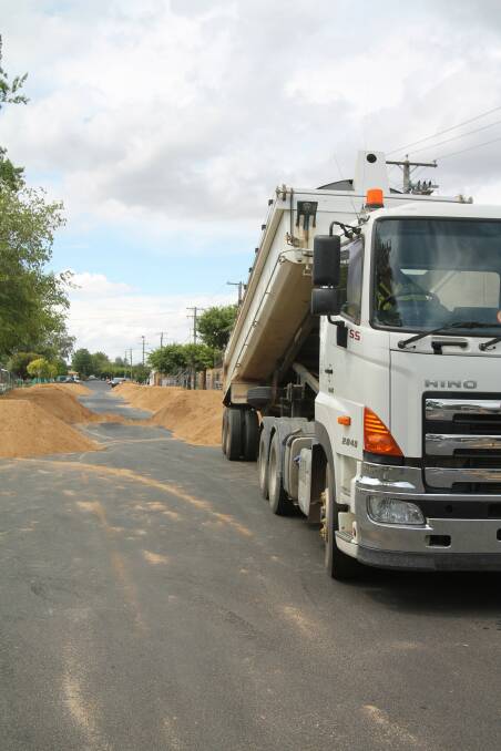Cootamundra-Gundagai Regional Council tip truck, driver Jay Bone, dumps sand in Murray Street ready for conversion to beach volleyball courts by Fallon's Excavations.