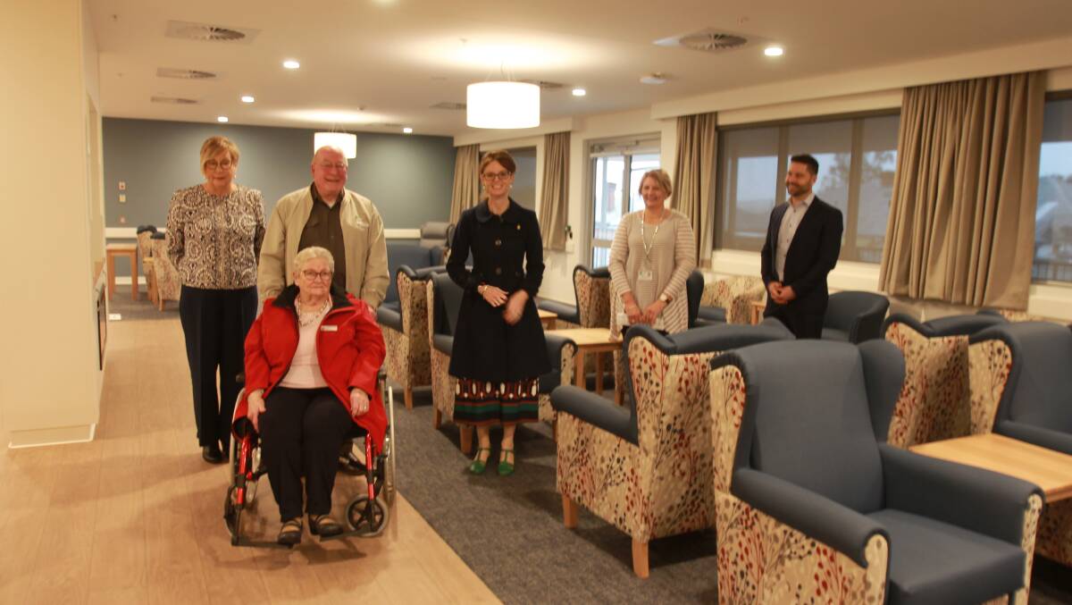 Home-like: Ms Cooke (centre) in the lounge area of the residential aged care section, with (from left) Marianne Warren, MLHD, John and Carol Ford, Michelle Cotrell-Smith, MLHD and Nick Di Condio, Health infrastructure. 