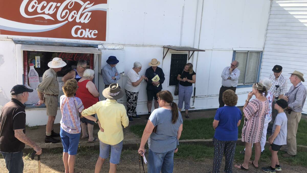 Annie Jacobs (rear, under awning) and Greg Quirk with Wallendbeen residents interested in establishing a community-run post office 