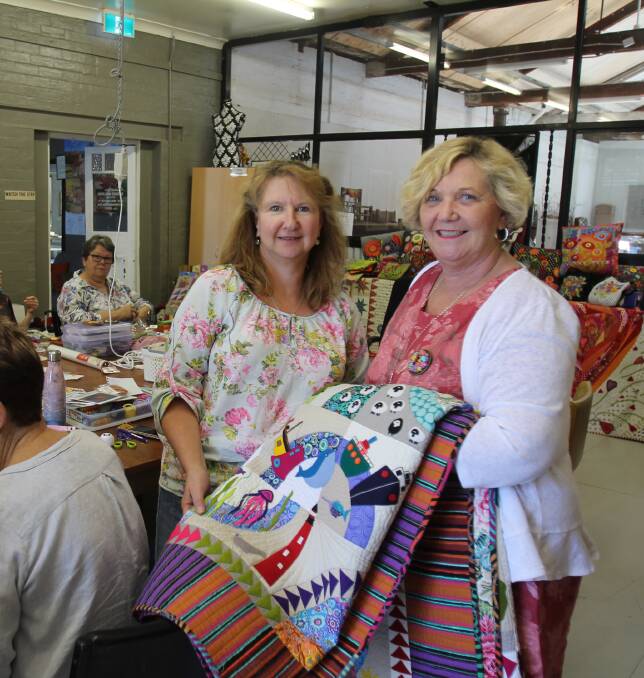 Wendy Williams (right) with Janelle Noack. In Coota for three days, Ms Williams taught wool felt and embroidery quilts to students in the group Ms Noack runs every Wednesday.