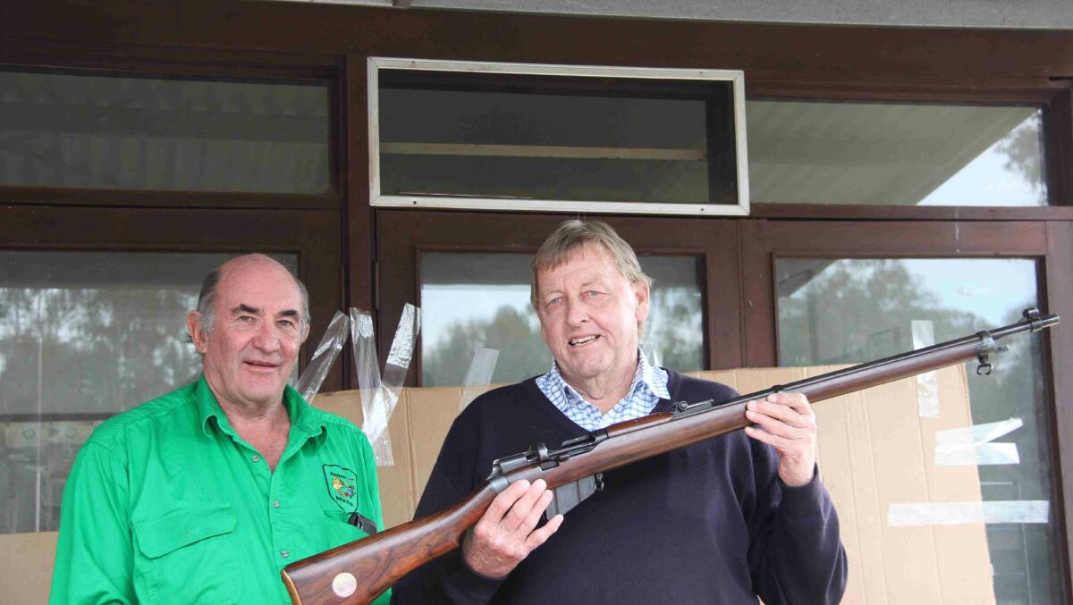 Cootamundra-Gundagai mayor Abb McAlister holding the rifle his great-uncle, later killed in World War I, won in England in 1913. With him is the RDRA's Graham Crowe. Picture: Contributed
