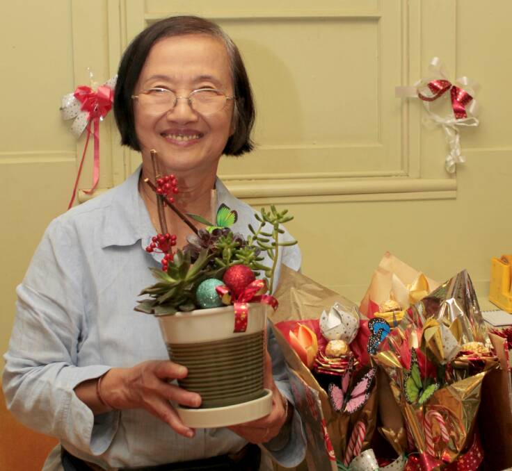 Trong Jenkins with her mixed arrangements that were on sale at the Christmas Gift Market in the Cootamundra Scout Hall.