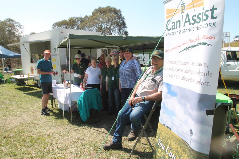 Orienteer Bruce Bowen from Duffy, ACT, buying a sausage sandwich from the CanAssist trailer at Wonona on Monday. Volunteers pictured are Picture are: (right to left): Murray Izzard, Jason Carroll, Bev Withers, Kylie Bateup, Mavis Bracken, Joan Woods, Marg Somers and Ray Wood.