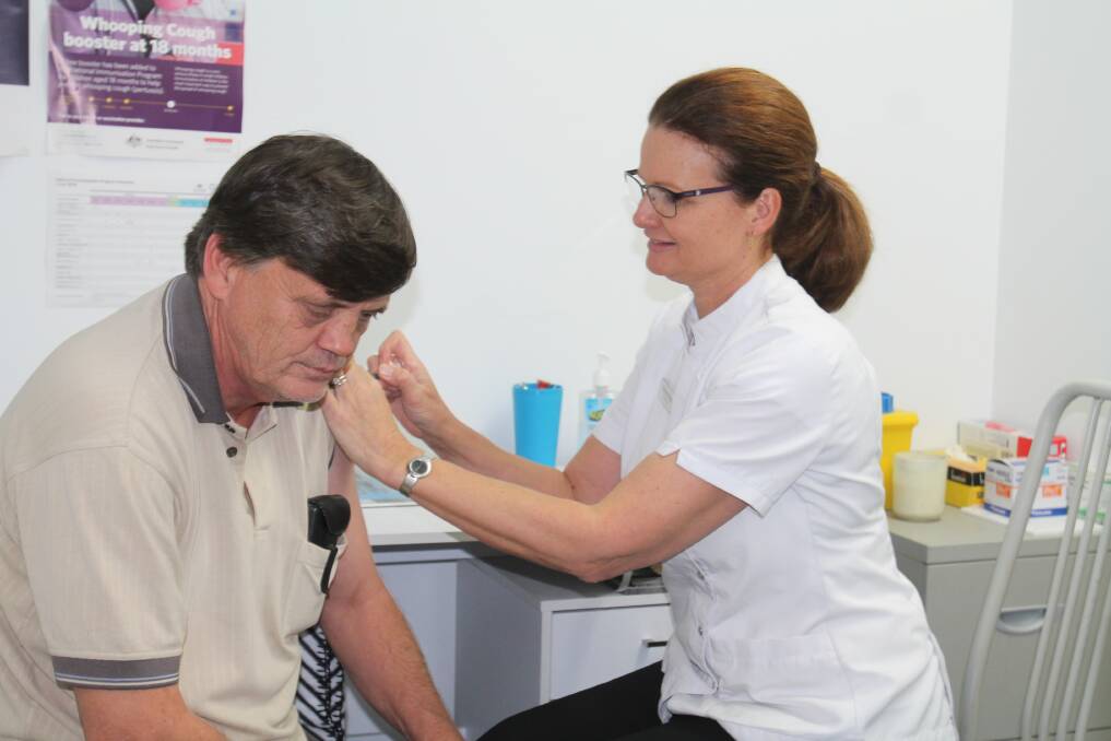 Trevor Minchin, of Stockinbingal, gets his flu shot from Rebecca Bragg at Beddies Pharmacy. Quadrivalent vaccine injections are available for $19.95.