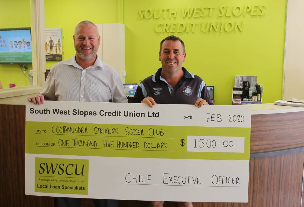 SWSCU CEO Scott Meale presents Strikers president Andrew Parkinson with the 2020 gold sponsor cheque. The Strikers "strips", or shirts, will carry logos of SWSCU, the Ex-Servicemen's Club and Indpendent Kitchens. 
