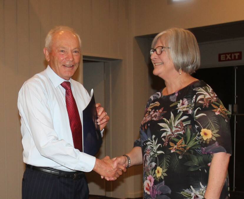 Carolynne Merchant, Director of Educational Leadership for Temora and Cootamundra schools, presents a certificate to the school, accepted by former principal Barry Cant.