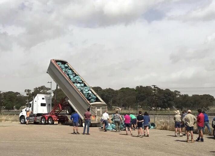 SALVAGE: Cootamundra Rugby Union Club takes delivery of 1000 recycled chairs from a Sydney stadium after members took a road trip.