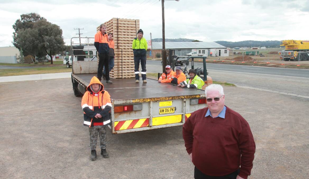 Elouera Association chief executive Allan Young with employees as they load another truck on Thursday. Photo: Declan Rurenga
