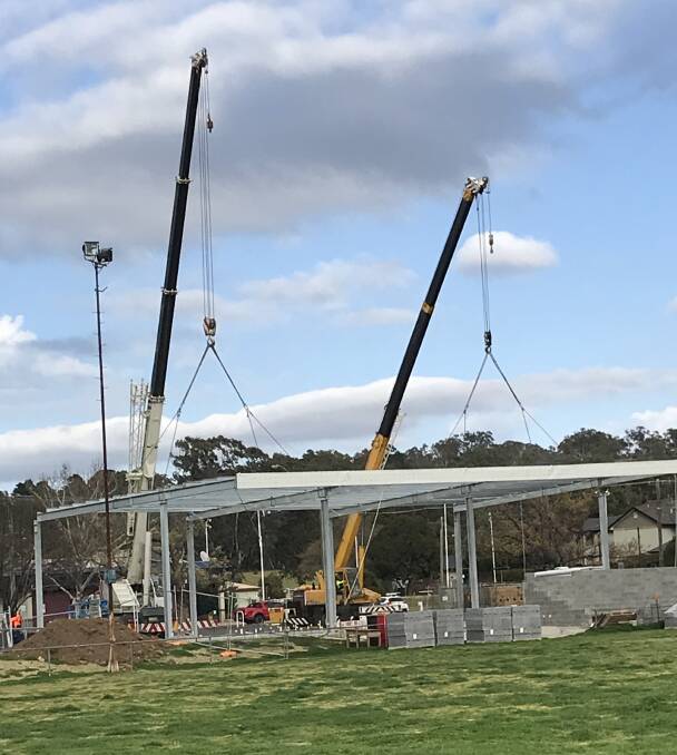 Cranes move the new roof into position at Cootamundra Country Club Oval for the new amenities bloc