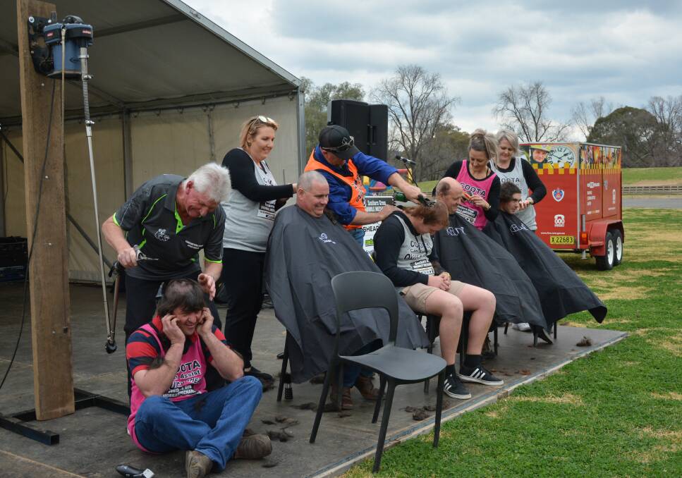 SHORN: Southern Cross Mobile Mechanics volunteers take a drastic haircut at Wattle Time Fair last month to raise money for charity.