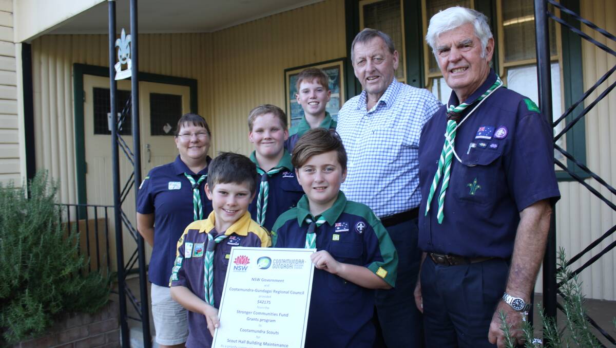 UPGRADE: CGRC mayor Cr Abb McAlister presents a plaque to Cootamundra Scout leaders Majory Taprell and Russell Wray, with scouts Tyson Gould, James Moore, Ethan Campbell and Paul Bean.