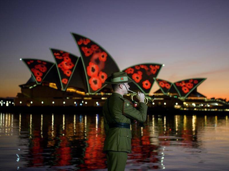 A defence bugler played the Last Post in front of the Sydney Opera House to mark Remembrance Day. (Bianca De Marchi/AAP PHOTOS)