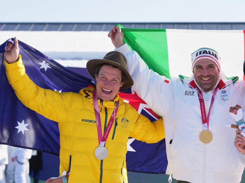 Ben Tudhope enjoys his silver medal next to Paralympic snowboard cross champ Emanuel Perathoner. Photo: AP PHOTO