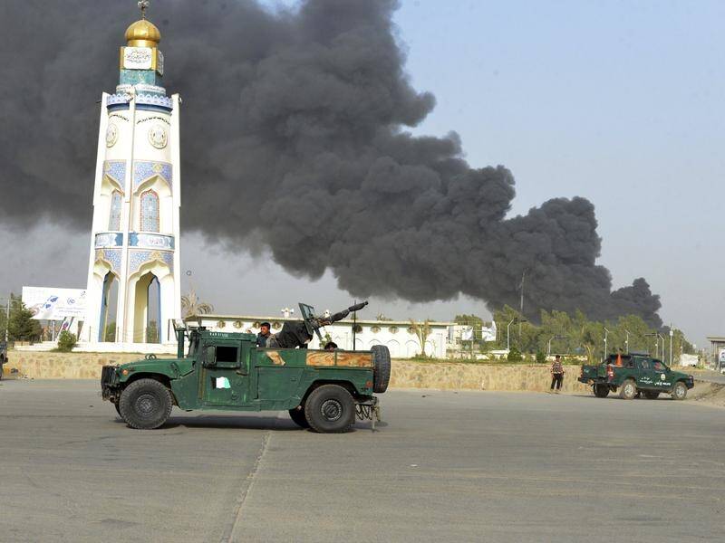 Two cars bombs have exploded at a gate outside police headquarters in the Afghan city of Kandahar.
