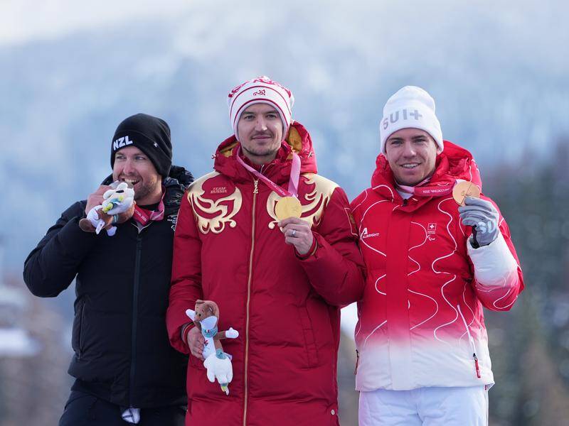 Adam Hall (l) with Russian winner Aleksei Bugaev (c) and bronze medallist Robin Cuche. Photo: AP PHOTO