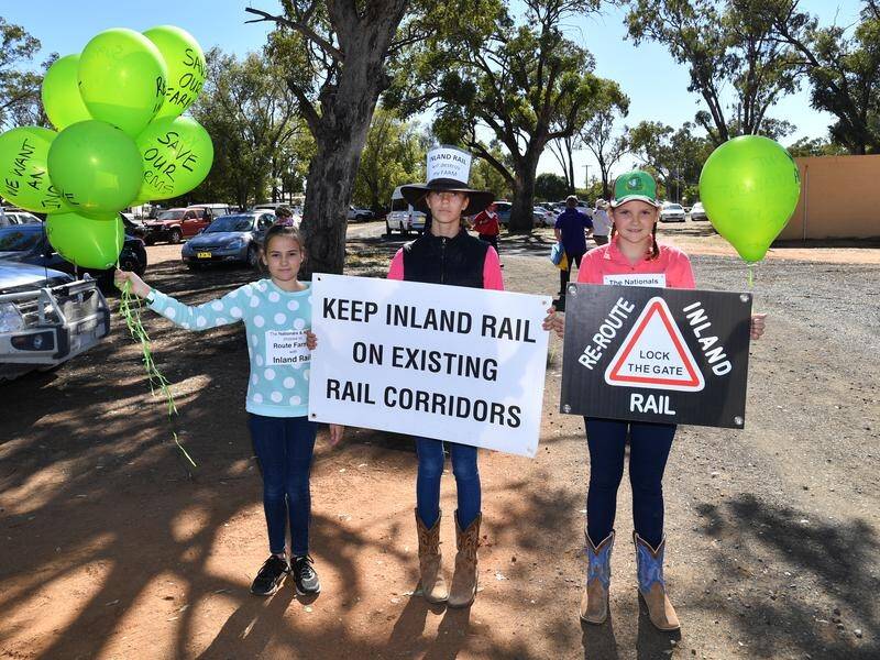 Three young girls protesting the inland rail at the Gilgandra Show.